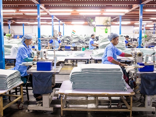 Workers sewing textiles in a modern factory